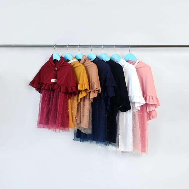 Girls' party frocks in different colours on a clothes rail
