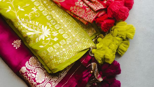 Folded embroidered suit fabrics and dupattas with tassels